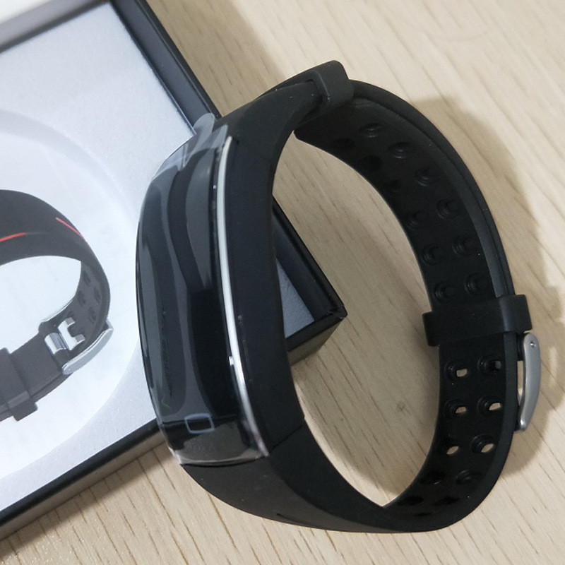 Black fitness tracker with OLED display and red accent lines on the wrist strap