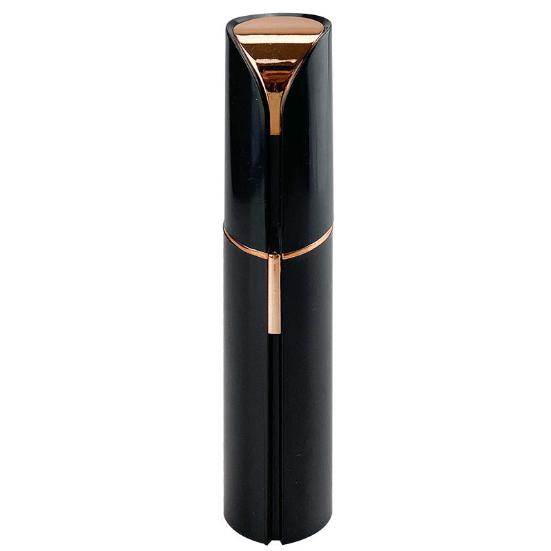Pink facial hair remover with gold-tone top and central grooming trigger