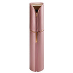 Rose gold and pink facial hair trimmer with circular grooming head and protective cap