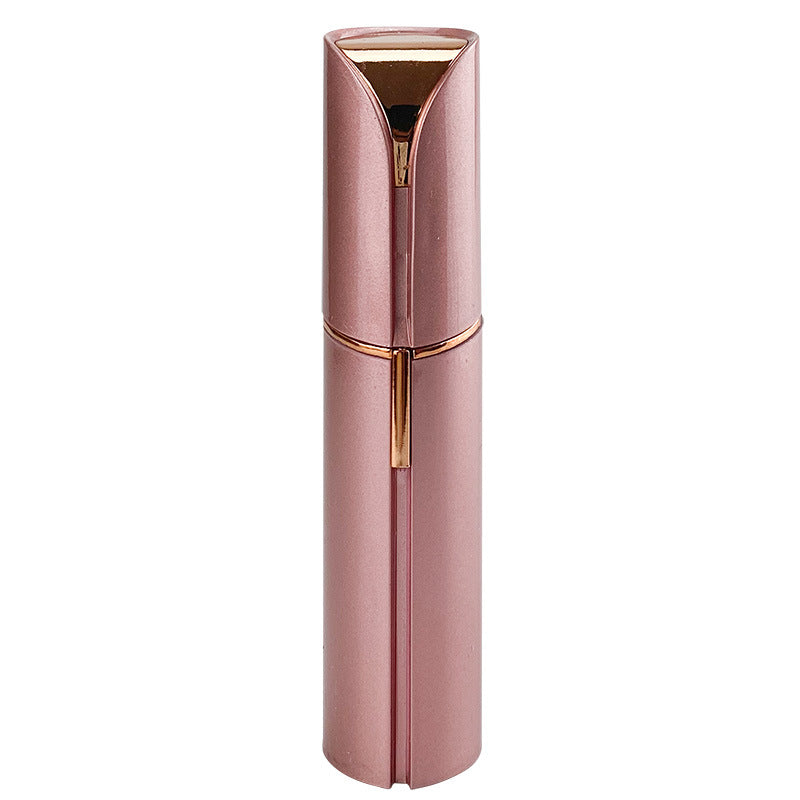 Rose gold and pink facial hair trimmer with circular grooming head and protective cap