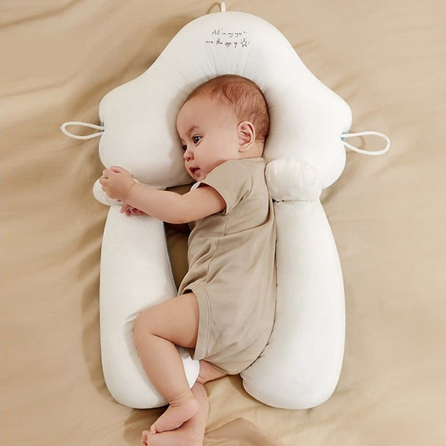 White ergonomic baby cushion with adjustable support, holding a seated baby